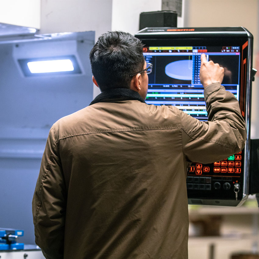 Cencal CNC employee working on CNC Machine in the Central Valley